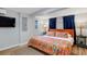 Stylish bedroom with a bright orange patterned comforter set and cozy rug on the hardwood floor at 4705 Hollingsworth Ave, Sarasota, FL 34233