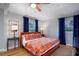 Bright bedroom with hardwood floors, colorful bedding, and bright windows offering natural light and style at 4705 Hollingsworth Ave, Sarasota, FL 34233