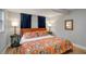 Inviting bedroom showcasing colorful bedding, wood floors, and bedside tables with lamps at 4705 Hollingsworth Ave, Sarasota, FL 34233