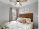 Relaxing bedroom with a decorative headboard, coastal-themed bedding, and a ceiling fan at 4705 Hollingsworth Ave, Sarasota, FL 34233