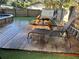 Wooden deck with picnic table, chairs, and loungers for outdoor relaxation and dining at 4705 Hollingsworth Ave, Sarasota, FL 34233