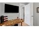 Gaming area featuring a large TV, a rustic wooden desk, and ample natural light at 4705 Hollingsworth Ave, Sarasota, FL 34233