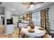 Bright dining area with a round table, stylish chairs, and hardwood floors at 4705 Hollingsworth Ave, Sarasota, FL 34233