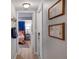 Hallway view to bedroom with colorful bedspread and bedside tables with lamps at 4705 Hollingsworth Ave, Sarasota, FL 34233