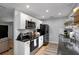 Modern kitchen featuring white cabinets, subway tile backsplash, and black appliances at 4705 Hollingsworth Ave, Sarasota, FL 34233