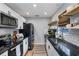 Modern kitchen featuring white cabinets, subway tile backsplash, and black appliances at 4705 Hollingsworth Ave, Sarasota, FL 34233