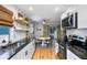 Kitchen boasts modern appliances, granite countertops, white cabinets, and adjacent dining area at 4705 Hollingsworth Ave, Sarasota, FL 34233
