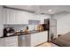 Modern kitchen featuring white cabinets, granite countertops, stainless steel appliances, and tiled backsplash at 4705 Hollingsworth Ave, Sarasota, FL 34233