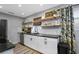 Modern kitchen with white cabinets, granite countertops, stainless steel appliances and hardwood floors at 4705 Hollingsworth Ave, Sarasota, FL 34233