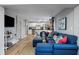Open-concept living space features a modern kitchen, dining area, and a cozy living room with a blue sofa at 4705 Hollingsworth Ave, Sarasota, FL 34233