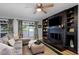 Spacious living room with a fireplace, built-in shelving, and sliding glass doors that fill the room with natural light at 4705 Hollingsworth Ave, Sarasota, FL 34233