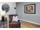 Cozy seating area with leather chair, round mirror, and nautical-themed artwork, creating a relaxing ambiance at 4705 Hollingsworth Ave, Sarasota, FL 34233