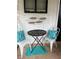 Cozy porch featuring chairs, throw pillows, table and metal fish decoration at 4705 Hollingsworth Ave, Sarasota, FL 34233