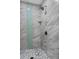 Elegant shower with marble-look tiles and a mosaic-tiled shower floor at 4705 Hollingsworth Ave, Sarasota, FL 34233