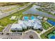 Aerial view of a community clubhouse, pool, and amenities surrounded by a neighborhood, with a lake and expansive green spaces at 5129 Marina Basin Ct, Bradenton, FL 34211