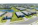 Wide aerial view of a new construction community with a lake and a single-story home at 5129 Marina Basin Ct, Bradenton, FL 34211