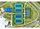 Aerial view highlighting tennis and basketball courts, plus putting green surrounded by lush landscaping at 5129 Marina Basin Ct, Bradenton, FL 34211