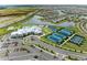 Panoramic aerial view showcasing the community clubhouse, pool, tennis courts, and surrounding neighborhood with lakes and green spaces at 5129 Marina Basin Ct, Bradenton, FL 34211