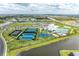 Aerial view showcases the community's amenities, including tennis courts, pools, and clubhouse at 5129 Marina Basin Ct, Bradenton, FL 34211