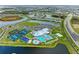 Wide aerial view of a community with lakes and homes surrounding clubhouse, pool, tennis, basketball, and other amenities at 5129 Marina Basin Ct, Bradenton, FL 34211