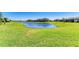Lush green backyard view showcasing a serene pond, perfect for enjoying nature at 5129 Marina Basin Ct, Bradenton, FL 34211