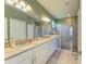 Bathroom features a double vanity with granite countertop and a glass-enclosed shower at 5129 Marina Basin Ct, Bradenton, FL 34211