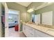 Bathroom featuring granite countertop, double sink, and an entrance into the main bedroom at 5129 Marina Basin Ct, Bradenton, FL 34211