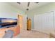 Neutral bedroom with a ceiling fan, double door closet, and a television at 5129 Marina Basin Ct, Bradenton, FL 34211