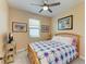 Cozy bedroom with a light wood bed frame, soft carpet, and a ceiling fan for added comfort at 5129 Marina Basin Ct, Bradenton, FL 34211