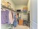 A walk-in closet featuring wire shelving, hanging clothes, and stacked shoeboxes at 5129 Marina Basin Ct, Bradenton, FL 34211