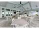 Outdoor dining area with ample seating, overhead fans, and a stylish bar for entertaining guests at 5129 Marina Basin Ct, Bradenton, FL 34211