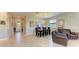 Open dining room with tile floors, large windows, and a view of the front yard at 5129 Marina Basin Ct, Bradenton, FL 34211