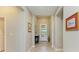 Bright hallway featuring tile flooring, neutral walls, and decorative wall art at 5129 Marina Basin Ct, Bradenton, FL 34211