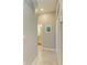 Hallway with access to the bathroom with tile floors and neutral paint at 5129 Marina Basin Ct, Bradenton, FL 34211