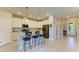 Modern kitchen featuring an island with seating, stainless steel appliances, and granite countertops at 5129 Marina Basin Ct, Bradenton, FL 34211