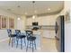 Kitchen featuring a large island with barstools, stainless steel appliances, and modern lighting at 5129 Marina Basin Ct, Bradenton, FL 34211