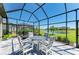 Lanai features dining table with chairs and outdoor views of the lake at 5129 Marina Basin Ct, Bradenton, FL 34211