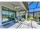 Screened lanai with comfortable seating, ceiling fan, and sliding glass doors to the interior at 5129 Marina Basin Ct, Bradenton, FL 34211