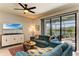 Comfortable living room featuring a ceiling fan and sliding doors leading to a screened-in lanai at 5129 Marina Basin Ct, Bradenton, FL 34211