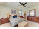 Main bedroom features dual nightstands, closet with connecting bathroom, and carpeted floors at 5129 Marina Basin Ct, Bradenton, FL 34211