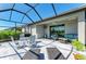 Spacious covered patio featuring comfortable seating, dining area, and tiled floors at 5129 Marina Basin Ct, Bradenton, FL 34211