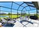 Enjoy outdoor living on this large, screened patio with a view of the lush backyard and tranquil pond at 5129 Marina Basin Ct, Bradenton, FL 34211