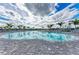 Large pool with brick paver deck, palm trees, and blue skies in a community setting at 5129 Marina Basin Ct, Bradenton, FL 34211