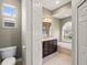 Bathroom features a dark wood vanity, soaking tub, and natural light from an arched window at 5354 Nathaniel Pl, Sarasota, FL 34233