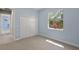 Carpeted bedroom featuring a double door closet and a window providing natural light at 5354 Nathaniel Pl, Sarasota, FL 34233