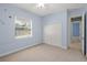 Bright bedroom featuring a ceiling fan, a neutral carpet, and a window providing natural light at 5354 Nathaniel Pl, Sarasota, FL 34233