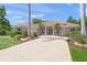 Beautiful home featuring a tiled roof, arched windows, columns, palm trees, and a paver driveway at 5354 Nathaniel Pl, Sarasota, FL 34233