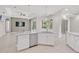 Bright kitchen featuring white cabinets, stainless steel appliances, pendant lights, and bar seating at 5354 Nathaniel Pl, Sarasota, FL 34233