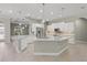 Gourmet kitchen featuring white cabinets, stainless steel appliances, pendant lights, and expansive island at 5354 Nathaniel Pl, Sarasota, FL 34233