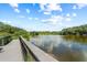 A picturesque lakeside view from the wooden deck, offering a tranquil escape into nature at 5354 Nathaniel Pl, Sarasota, FL 34233